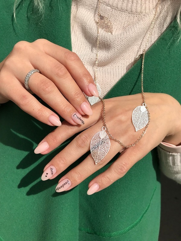 Minimalist nude manicure with lettering is a modern nail design in natural shades featuring subtle text accents. Perfect for a clean, stylish, and personalized look.